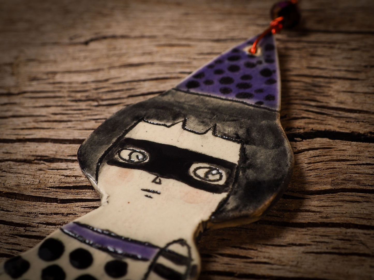An original handmade Halloween ornament by Idania Salcido, Danita Art. Each ornament is hand carved with pumpkins, witches, cats, jack-o-lanterns and moons. Made with fired glazed ceramics, this little witch, jack-o-lantern and cat is carved with delicate patterns that make each ornament a one of a kind work of art.