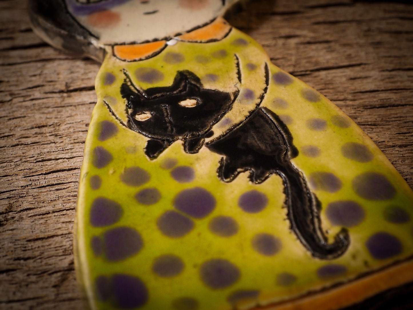 An original handmade Halloween ornament by Idania Salcido, Danita Art. Each ornament is hand carved with pumpkins, witches, cats, jack-o-lanterns and moons. Made with fired glazed ceramics, this little witch, jack-o-lantern and cat is carved with delicate patterns that make each ornament a one of a kind work of art.