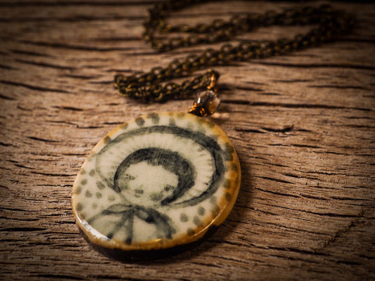 Unique fired ceramic porcelain necklace oval pendant by Idania Salcido, the artist behind Danita Art. Each jewelry setting is hand drawn and illustrated by the artist in her art studio, perfect for any dressing style. A casual gathering with friends or a fancy formal dinner, this necklace is a perfect fashion accessory