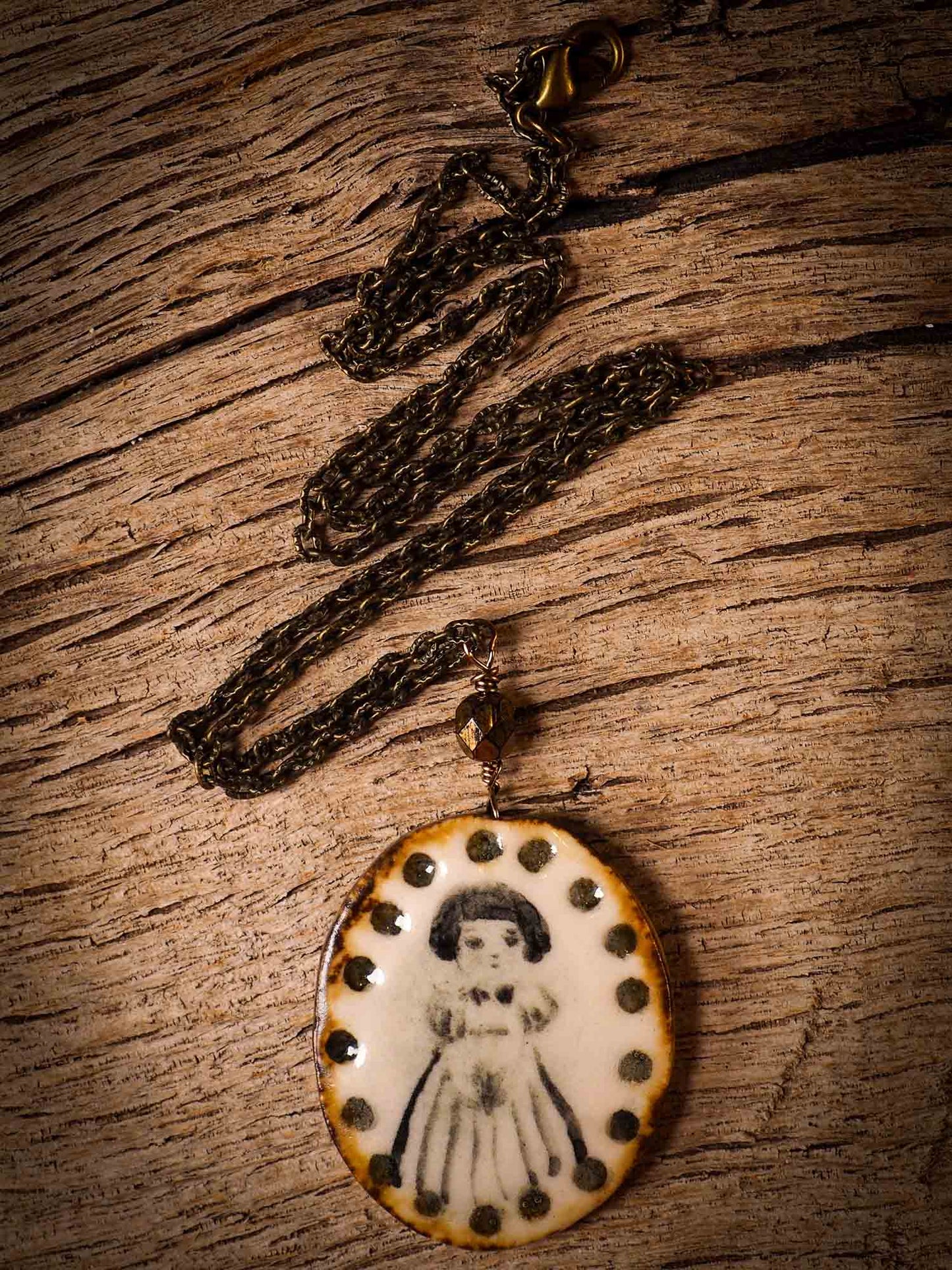 Unique fired ceramic porcelain necklace oval pendant by Idania Salcido, the artist behind Danita Art. Each jewelry setting is hand drawn and illustrated by the artist in her art studio, perfect for any dressing style. A casual gathering with friends or a fancy formal dinner, this necklace is a perfect fashion accessory.
