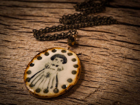 Unique fired ceramic porcelain necklace oval pendant by Idania Salcido, the artist behind Danita Art. Each jewelry setting is hand drawn and illustrated by the artist in her art studio, perfect for any dressing style. A casual gathering with friends or a fancy formal dinner, this necklace is a perfect fashion accessory.