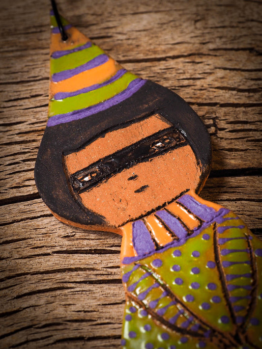 An original handmade Halloween ornament by Idania Salcido, Danita Art. Each ornament is hand carved with pumpkins, witches, cats, jack-o-lanterns and moons. Made with fired glazed ceramics, this little witch, jack-o-lantern and cat is carved with delicate patterns that make each ornament a one of a kind work of art.