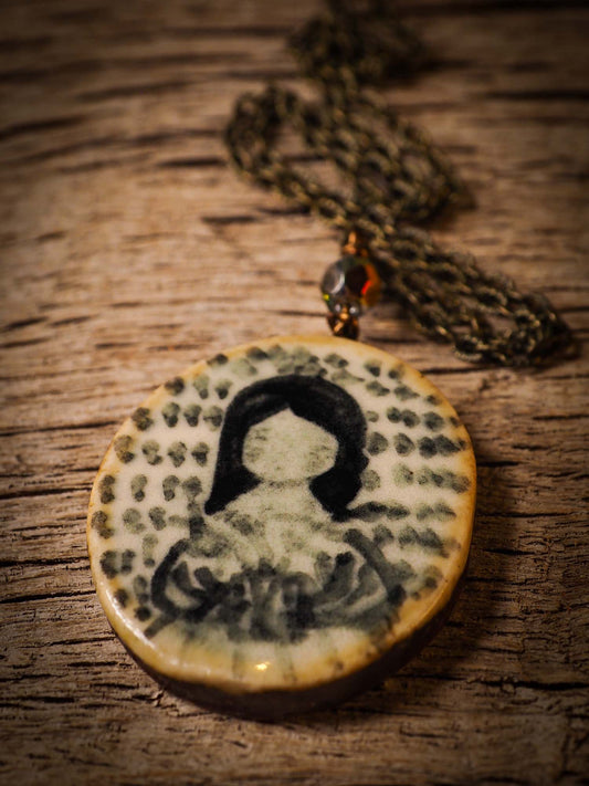 Unique fired ceramic porcelain necklace oval pendant by Idania Salcido, the artist behind Danita Art. Each jewelry setting is hand drawn and illustrated by the artist in her art studio, perfect for any dressing style. A casual gathering with friends or a fancy formal dinner, this necklace is a perfect fashion accessory.