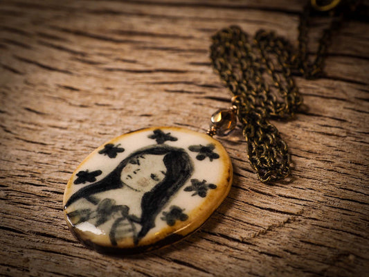 Unique fired ceramic porcelain necklace oval pendant by Idania Salcido, the artist behind Danita Art. Each jewelry setting is hand drawn and illustrated by the artist in her art studio, perfect for any dressing style. A casual gathering with friends or a fancy formal dinner, this necklace is a perfect fashion accessory.