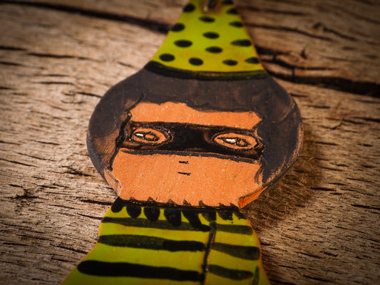 An original handmade Halloween ornament by Idania Salcido, Danita Art. Each ornament is hand carved with pumpkins, witches, cats, jack-o-lanterns and moons. Made with fired glazed ceramics, this little witch, jack-o-lantern and cat is carved with delicate patterns that make each ornament a one of a kind work of art.