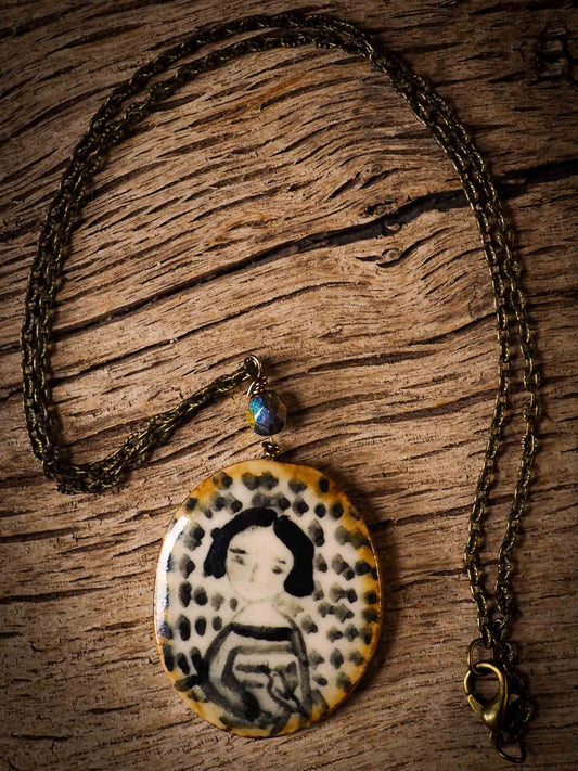 Unique fired ceramic porcelain necklace oval pendant by Idania Salcido, the artist behind Danita Art. Each jewelry setting is hand drawn and illustrated by the artist in her art studio, perfect for any dressing style. A casual gathering with friends or a fancy formal dinner, this necklace is a perfect fashion accessory.