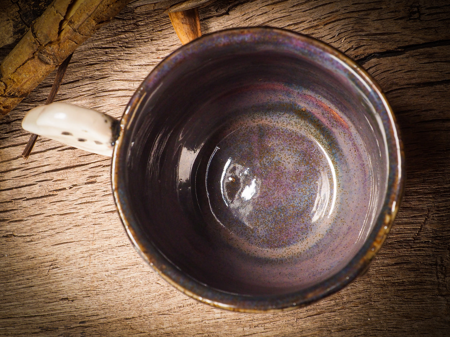 Fire glazed ceramic coffee mug by Idania Salcido, Danita Art. On Halloween, Danita creates ceramic containers for pumpkin spice coffee, warm tea or sweets to give on trick-or-treat night. With carved with Halloween ghosts, skeletons, witches, ghouls, black cats, jack-o-lanterns, item is food safe, hand wash only.