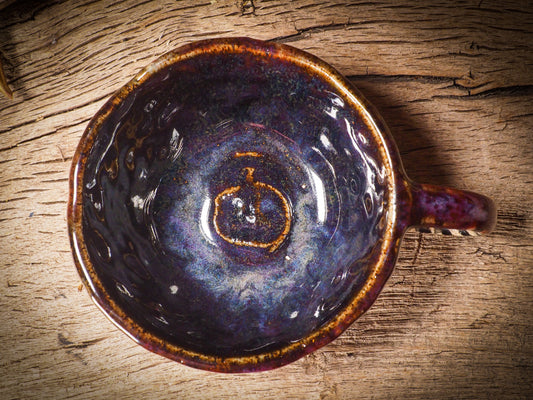 Fire glazed ceramic coffee mug by Idania Salcido, Danita Art. On Halloween, Danita creates ceramic containers for pumpkin spice coffee, warm tea or sweets to give on trick-or-treat night. With carved with Halloween ghosts, skeletons, witches, ghouls, black cats, jack-o-lanterns, item is food safe, hand wash only.