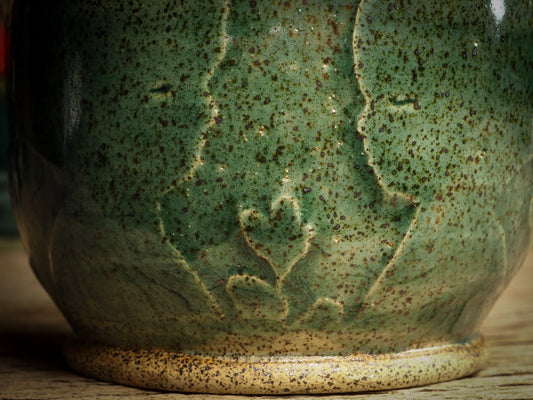 An original glazed ceramic jar by Idania Salcido, the artist behind Danita Art. It measures 3 x 3 x 3.5 Inches, with deep green hue glazes and hand decorated figures on the sides. Totally handmade in my studio, this is a unique piece that cannot be repeated. Food and drink safe, hand wash only.