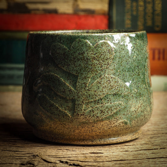 An original glazed ceramic jar by Idania Salcido, the artist behind Danita Art. It measures 3 x 3 x 3 Inches, with deep green hue glazes and hand decorated figures on the sides. Totally handmade in my studio, this is a unique piece that cannot be repeated. Food and drink safe, hand wash only.