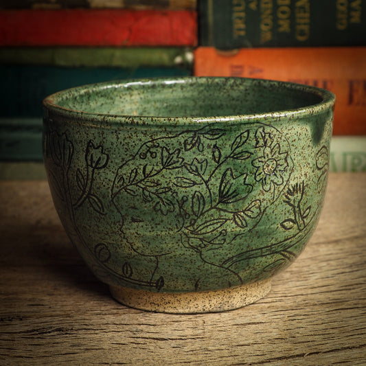 An original glazed ceramic mug by Idania Salcido, the artist behind Danita Art. It measures 4 x 4 x 3 Inches, with deep green hue glazes and hand decorated figures on the sides. Totally handmade in my studio, this is a unique piece that cannot be repeated. Food and drink safe, hand wash only.