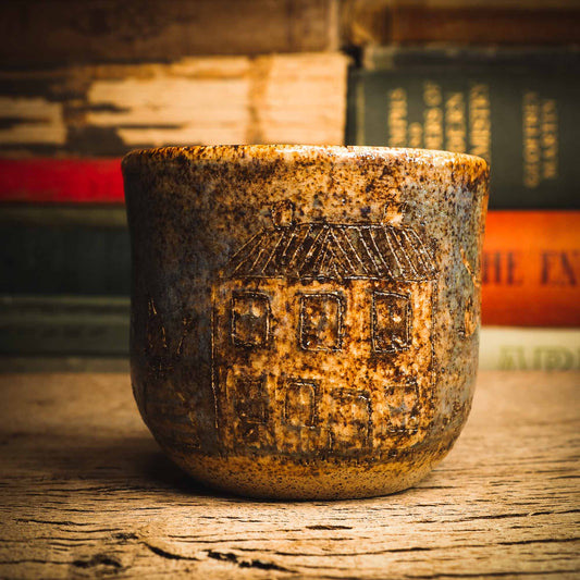 An original handmade fired stoneware ceramic art piece by Idania Salcido, the artist behind Danita Art. A Halloween themed mug perfect for enjoying ice cream, hot coffee or a delicious hot cocoa with primitive with house figures carved on it. Danita's exclusive line of housewares and hand made home decor will create beautiful memories for you.