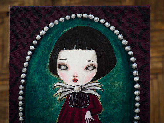 A little ghoul girl painted by Danita. She is ready to go trick-or-treat on Halloween night with her friends the ghosts, the witches, the werewolves and the monsters. Danita painted her while walking out of her door using acrylic and collage mixed media techniques. She has a pale skin face, but she still has those beautiful Danita eyes that you love.