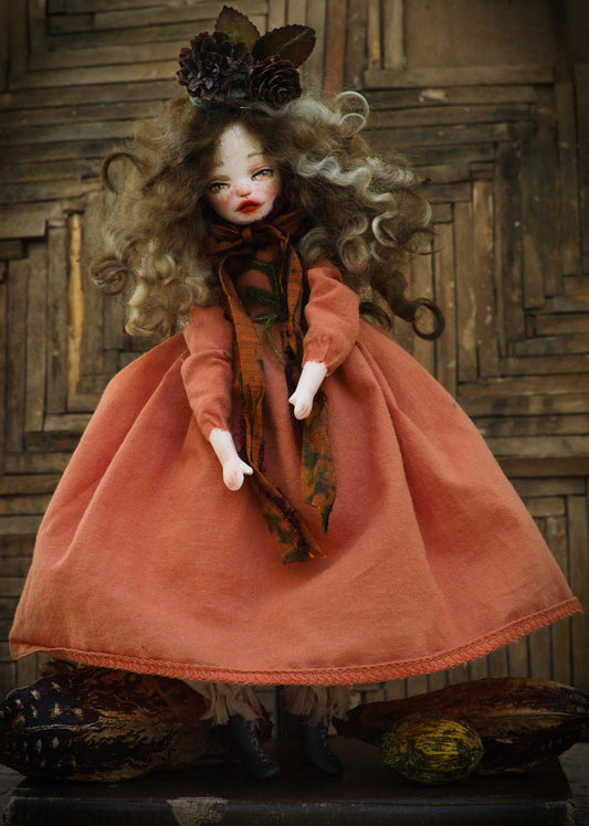 This is an original hand made Danita Art doll. She is inspired by the warm colors of leaves falling, pine cones and the beautiful scents of the forest in Autumn. Her name is ELA and she is protector of the trees and speaks for them. Dressed in a handmade burnt orange gown. Her hair is made of natural wool and she is wearing beautiful pine cones in her head.