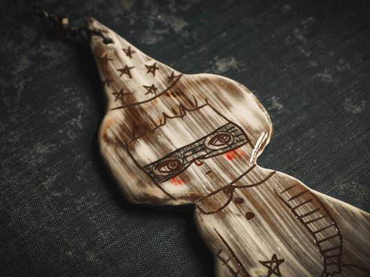 An original handmade Halloween ornament by Idania Salcido, Danita Art. Each ornament is hand carved with pumpkins, witches, cats, jack-o-lanterns and moons. Made with fired glazed ceramics, this little witch, jack-o-lantern and cat is carved with delicate patterns that make each ornament a one of a kind work of art.