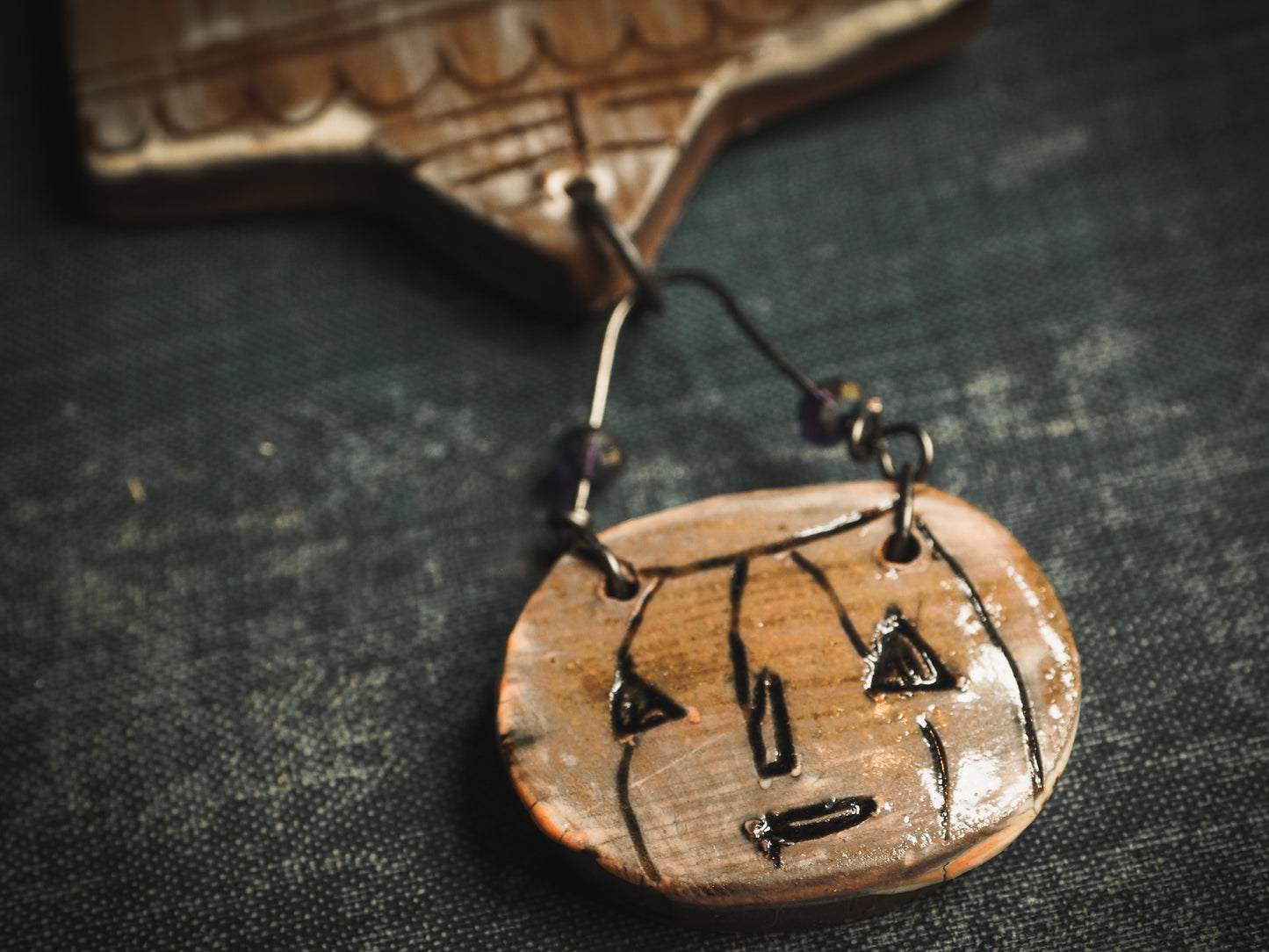 An original handmade Halloween ornament by Idania Salcido, Danita Art. Each ornament is hand carved with pumpkins, witches, cats, jack-o-lanterns and moons. Made with fired glazed ceramics, this little witch, jack-o-lantern and cat is carved with delicate patterns that make each ornament a one of a kind work of art.