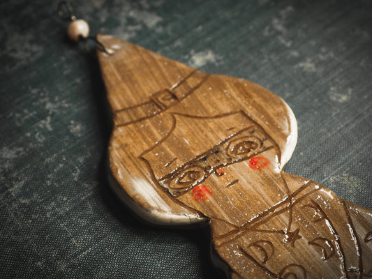 An original handmade Halloween ornament by Idania Salcido, Danita Art. Each ornament is hand carved with pumpkins, witches, cats, jack-o-lanterns and moons. Made with fired glazed ceramics, this little witch, jack-o-lantern and cat is carved with delicate patterns that make each ornament a one of a kind work of art.