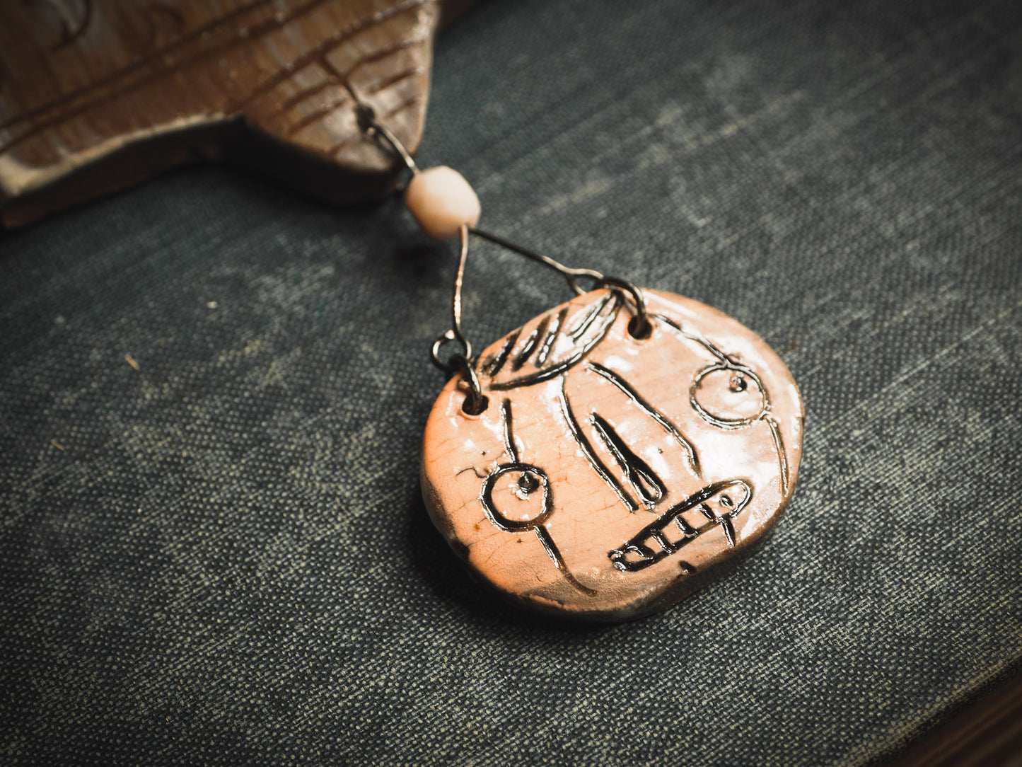 An original handmade Halloween ornament by Idania Salcido, Danita Art. Each ornament is hand carved with pumpkins, witches, cats, jack-o-lanterns and moons. Made with fired glazed ceramics, this little witch, jack-o-lantern and cat is carved with delicate patterns that make each ornament a one of a kind work of art.