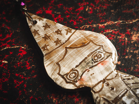 An original handmade Halloween ornament by Idania Salcido, Danita Art. Each ornament is hand carved with pumpkins, witches, cats, jack-o-lanterns and moons. Made with fired glazed ceramics, this little witch, jack-o-lantern and cat is carved with delicate patterns that make each ornament a one of a kind work of art.