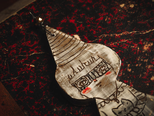 An original handmade Halloween ornament by Idania Salcido, Danita Art. Each ornament is hand carved with pumpkins, witches, cats, jack-o-lanterns and moons. Made with fired glazed ceramics, this little witch, jack-o-lantern and cat is carved with delicate patterns that make each ornament a one of a kind work of art.