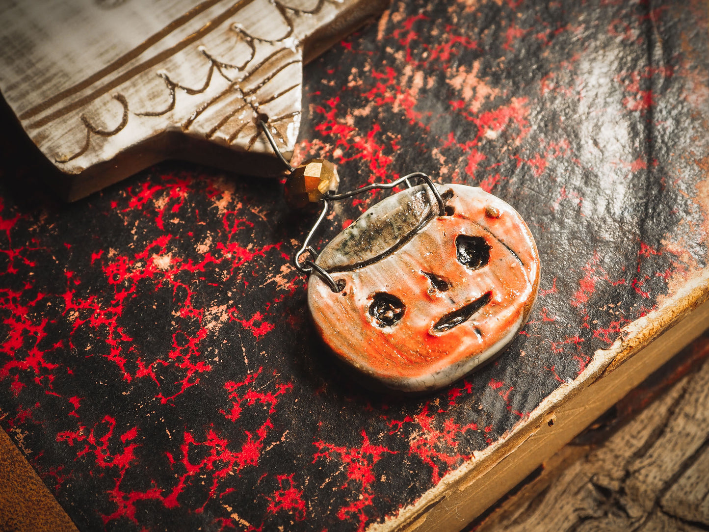 An original handmade Halloween ornament by Idania Salcido, Danita Art. Each ornament is hand carved with pumpkins, witches, cats, jack-o-lanterns and moons. Made with fired glazed ceramics, this little witch, jack-o-lantern and cat is carved with delicate patterns that make each ornament a one of a kind work of art.