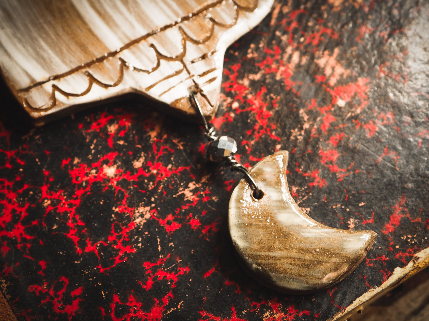 An original handmade Halloween ornament by Idania Salcido, Danita Art. Each ornament is hand carved with pumpkins, witches, cats, jack-o-lanterns and moons. Made with fired glazed ceramics, this little witch, jack-o-lantern and cat is carved with delicate patterns that make each ornament a one of a kind work of art.