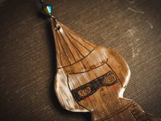 An original handmade Halloween ornament by Idania Salcido, Danita Art. Each ornament is hand carved with pumpkins, witches, cats, jack-o-lanterns and moons. Made with fired glazed ceramics, this little witch, jack-o-lantern and cat is carved with delicate patterns that make each ornament a one of a kind work of art.