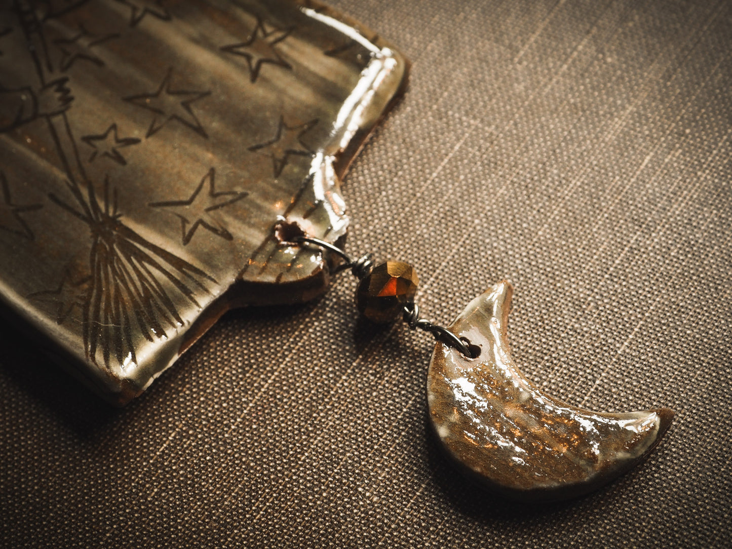 An original handmade Halloween ornament by Idania Salcido, Danita Art. Each ornament is hand carved with pumpkins, witches, cats, jack-o-lanterns and moons. Made with fired glazed ceramics, this little witch, jack-o-lantern and cat is carved with delicate patterns that make each ornament a one of a kind work of art.