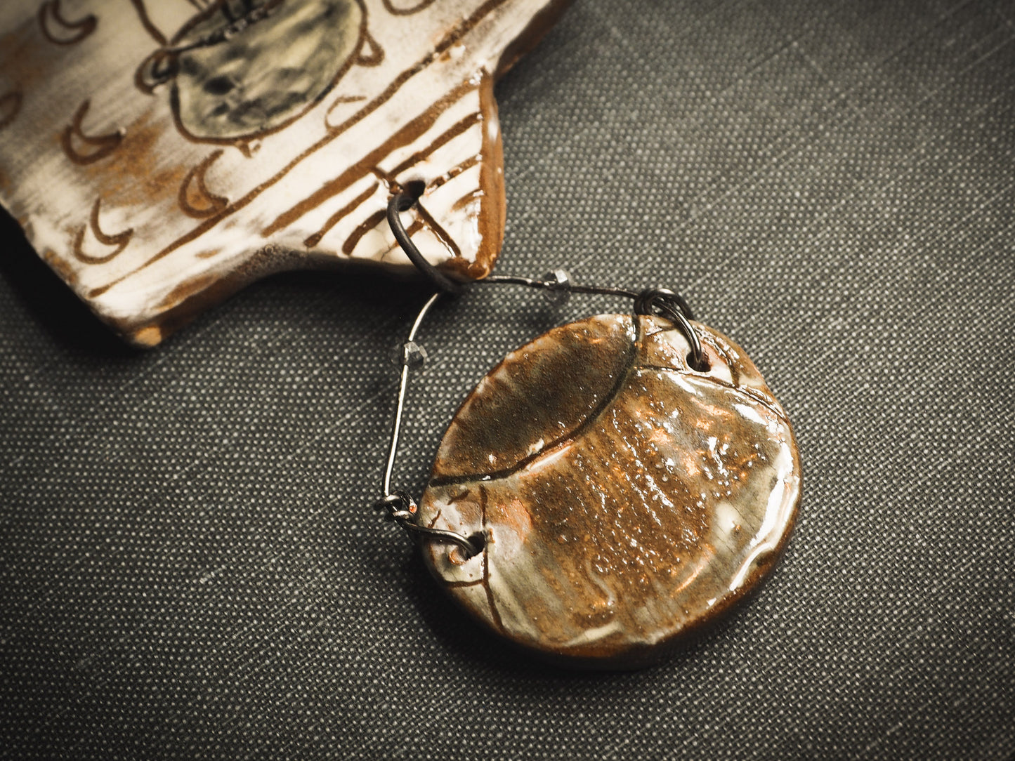 An original handmade Halloween ornament by Idania Salcido, Danita Art. Each ornament is hand carved with pumpkins, witches, cats, jack-o-lanterns and moons. Made with fired glazed ceramics, this little witch, jack-o-lantern and cat is carved with delicate patterns that make each ornament a one of a kind work of art.