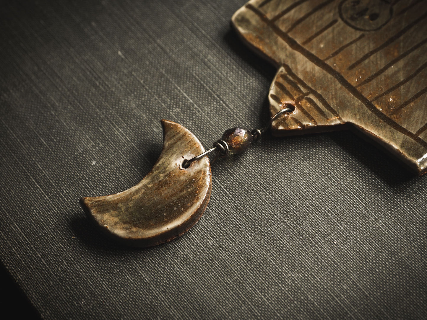 An original handmade Halloween ornament by Idania Salcido, Danita Art. Each ornament is hand carved with pumpkins, witches, cats, jack-o-lanterns and moons. Made with fired glazed ceramics, this little witch, jack-o-lantern and cat is carved with delicate patterns that make each ornament a one of a kind work of art.