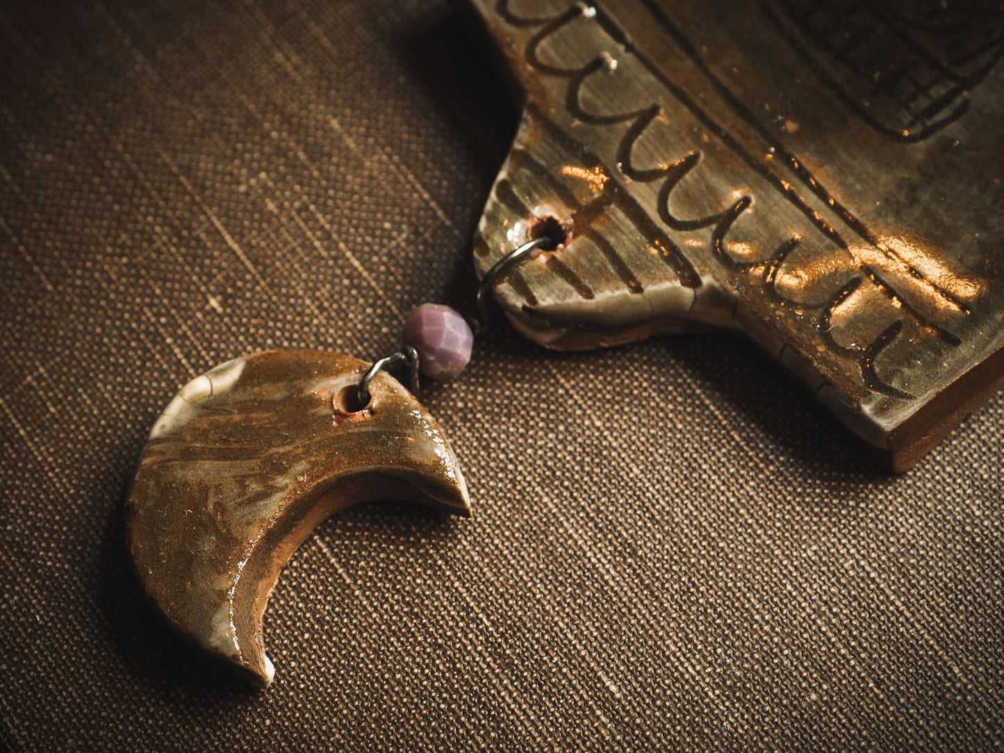 An original handmade Halloween ornament by Idania Salcido, Danita Art. Each ornament is hand carved with pumpkins, witches, cats, jack-o-lanterns and moons. Made with fired glazed ceramics, this little witch, jack-o-lantern and cat is carved with delicate patterns that make each ornament a one of a kind work of art.