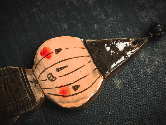 An original handmade Halloween ornament by Idania Salcido, Danita Art. Each ornament is hand carved with pumpkins, witches, cats, jack-o-lanterns and moons. Made with fired glazed ceramics, this little witch, jack-o-lantern and cat is carved with delicate patterns that make each ornament a one of a kind work of art.