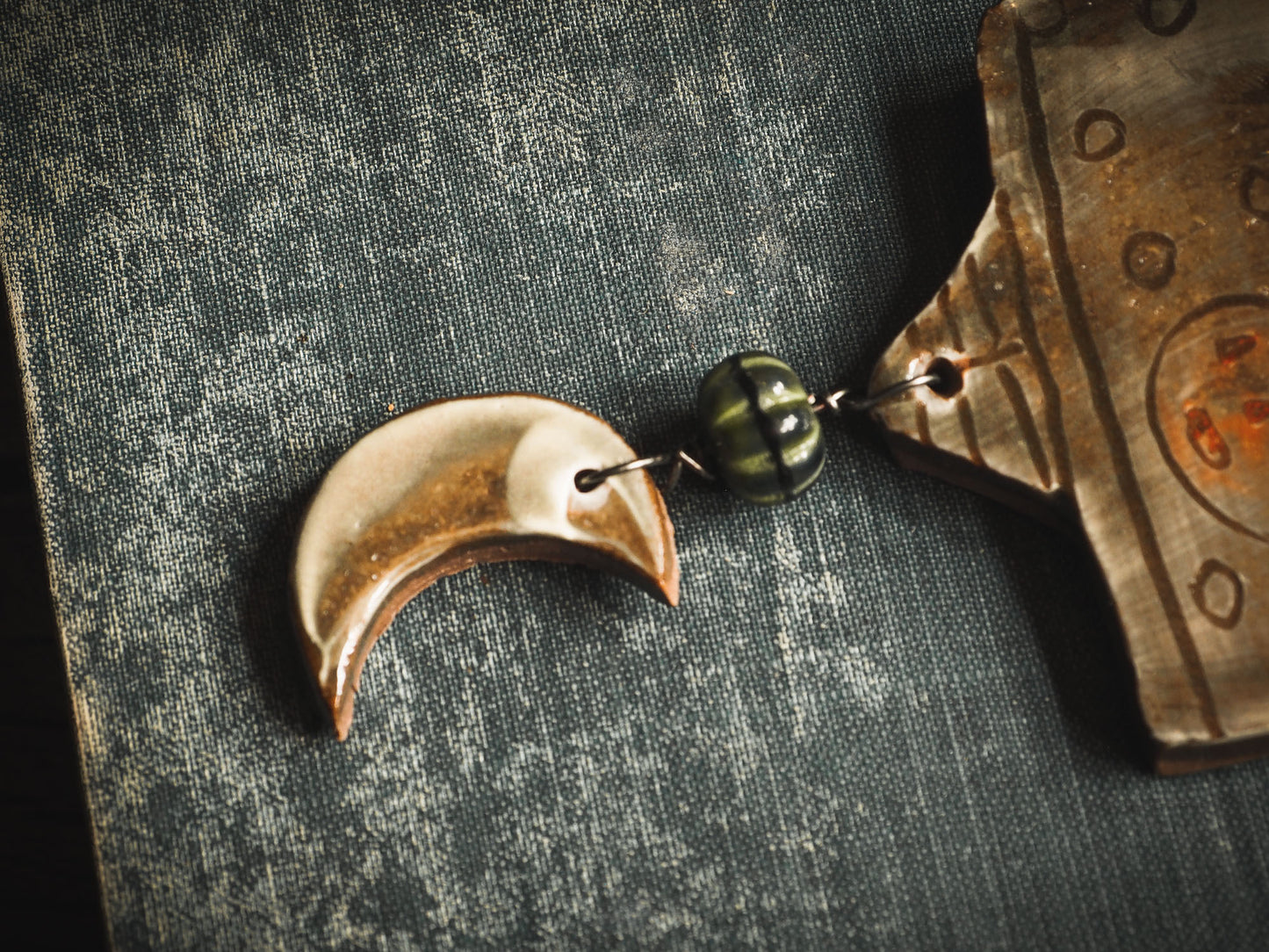 An original handmade Halloween ornament by Idania Salcido, Danita Art. Each ornament is hand carved with pumpkins, witches, cats, jack-o-lanterns and moons. Made with fired glazed ceramics, this little witch, jack-o-lantern and cat is carved with delicate patterns that make each ornament a one of a kind work of art.