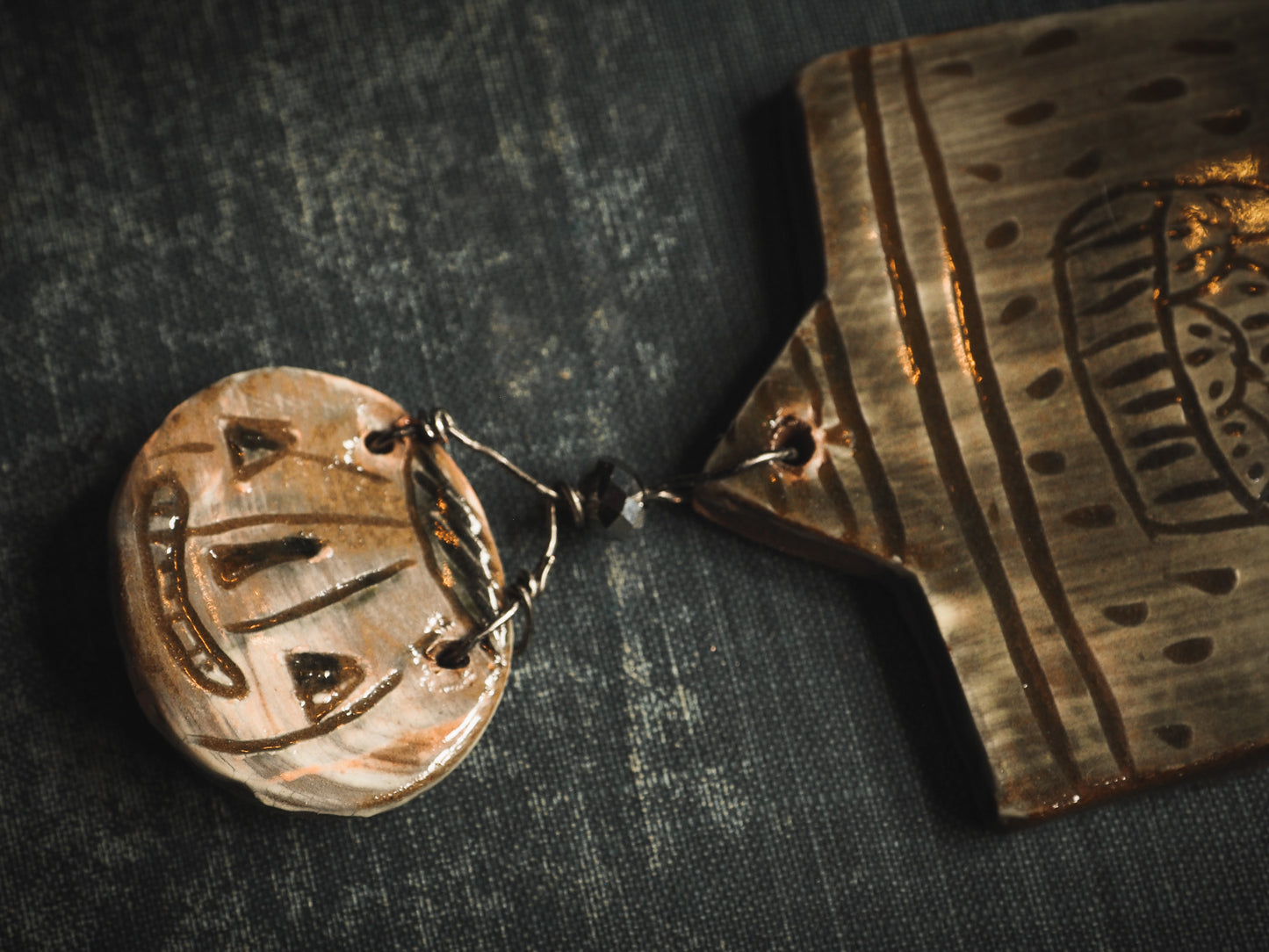 An original handmade Halloween ornament by Idania Salcido, Danita Art. Each ornament is hand carved with pumpkins, witches, cats, jack-o-lanterns and moons. Made with fired glazed ceramics, this little witch, jack-o-lantern and cat is carved with delicate patterns that make each ornament a one of a kind work of art.