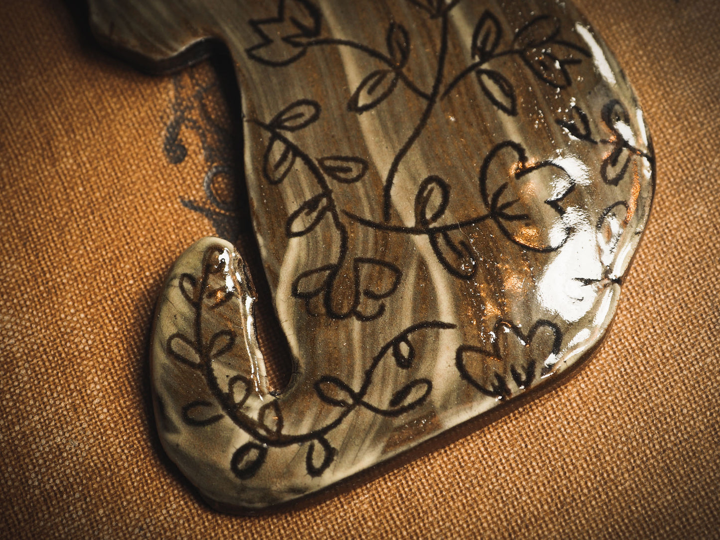 An original handmade Halloween ornament by Idania Salcido, Danita Art. Each ornament is hand carved with pumpkins, witches, cats, jack-o-lanterns and moons. Made with fired glazed ceramics, this little witch, jack-o-lantern and cat is carved with delicate patterns that make each ornament a one of a kind work of art.