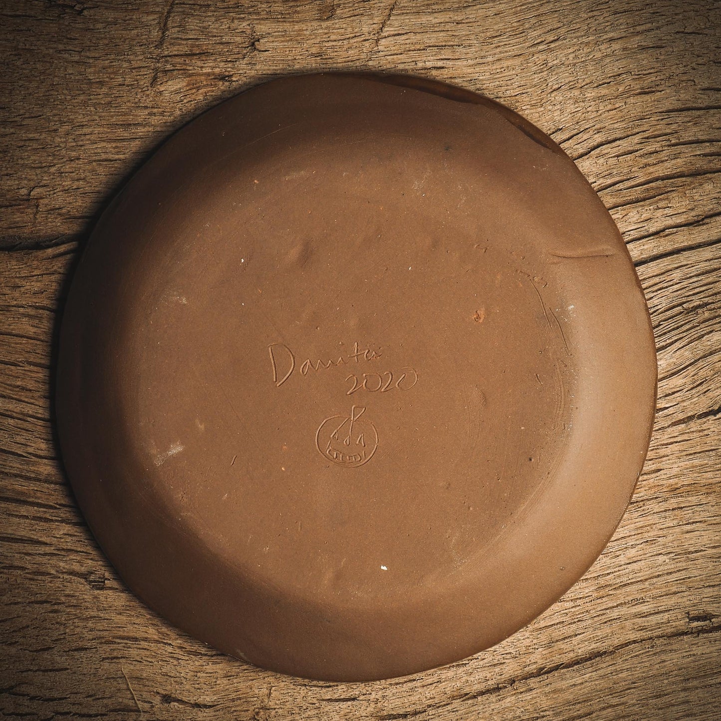 An original handmade Halloween ceramic dinner plate by Idania Salcido, Danita Art. Each plate is hand painted and glazed with pumpkins, witches, cats, jack-o-lanterns and moons. Made with fired glazed ceramics, this little witch, jack-o-lantern and cat plate is painted with delicate patterns that make it one of a kind artwork.