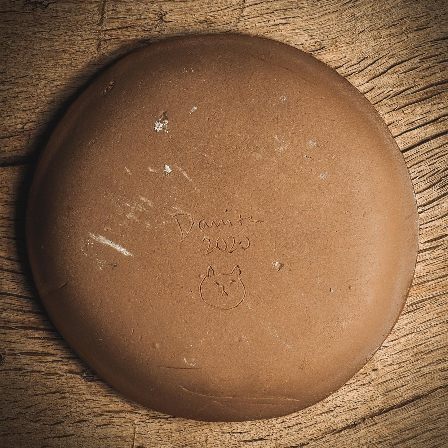 An original handmade Halloween ceramic dinner plate by Idania Salcido, Danita Art. Each plate is hand painted and glazed with pumpkins, witches, cats, jack-o-lanterns and moons. Made with fired glazed ceramics, this little witch, jack-o-lantern and cat plate is painted with delicate patterns that make it one of a kind artwork.