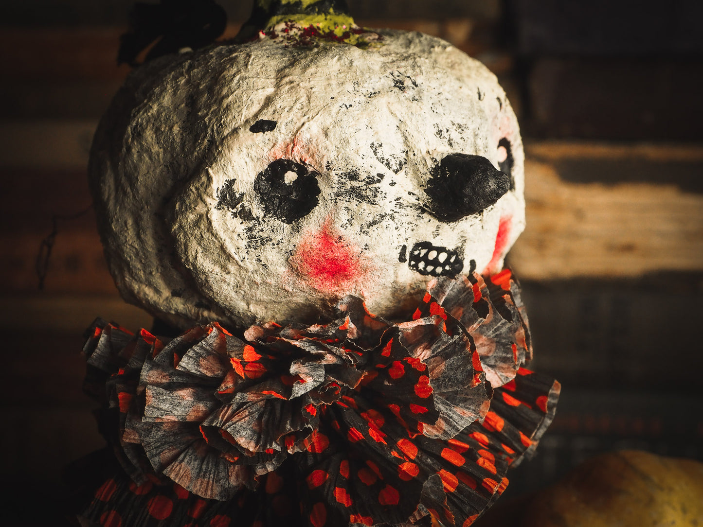 This adorable Halloween handmade ornament pumpkin jack-o-lantern doll monster by Idania Salcido, the artist behind Danita Art, is made with painted spun cotton and paper. It has hand painted face, teeth and eyes with a glittery paper had and matching paper costume. A Halloween home decoration on trick-or-treat night.