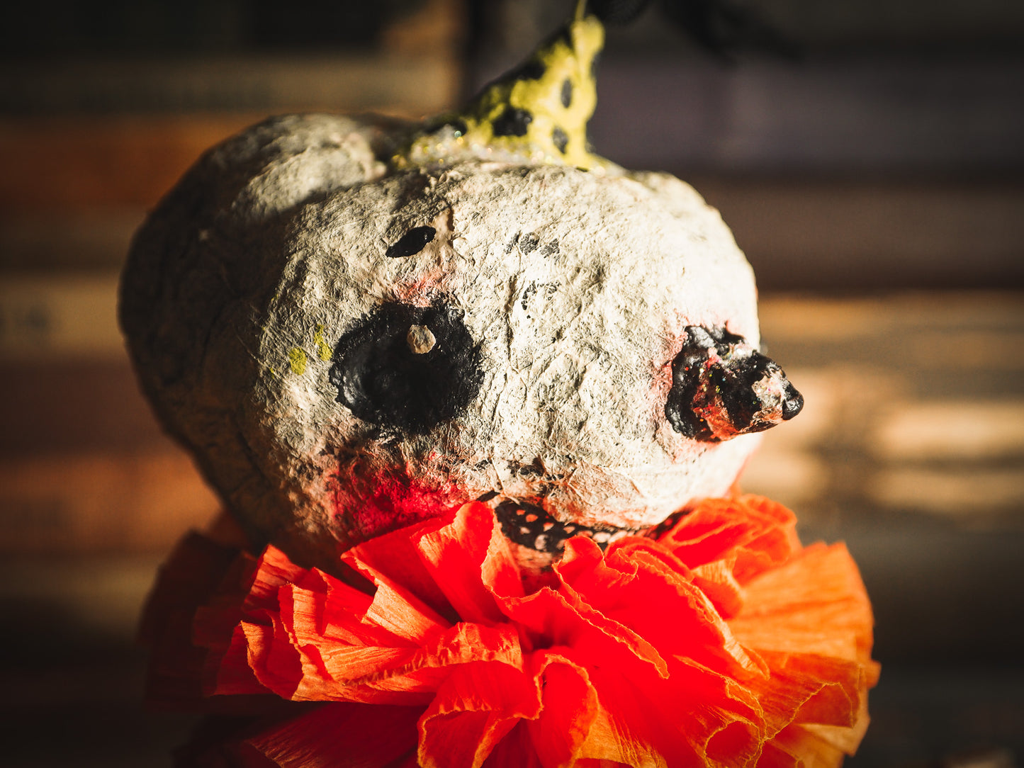 This adorable Halloween handmade ornament pumpkin jack-o-lantern doll monster by Idania Salcido, the artist behind Danita Art, is made with painted spun cotton and paper. It has hand painted face, teeth and eyes with a glittery paper had and matching paper costume. A Halloween home decoration on trick-or-treat night.