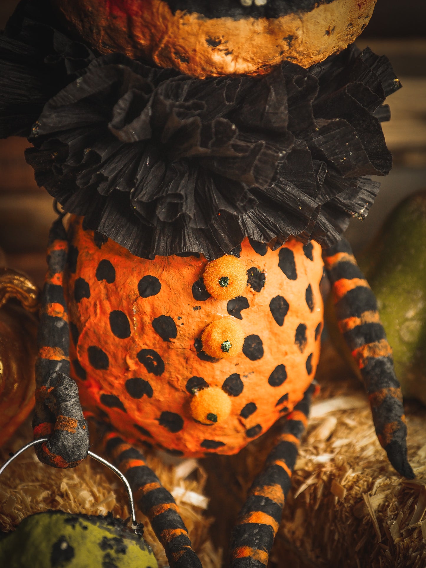 This adorable Halloween handmade ornament pumpkin jack-o-lantern doll monster by Idania Salcido, the artist behind Danita Art, is made with painted spun cotton and paper. It has hand painted face, teeth and eyes with a glittery paper had and matching paper costume. A Halloween home decoration on trick-or-treat night.
