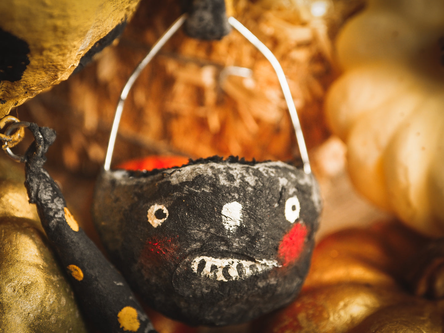 This adorable Halloween handmade ornament pumpkin jack-o-lantern doll monster by Idania Salcido, the artist behind Danita Art, is made with painted spun cotton and paper. It has hand painted face, teeth and eyes with a glittery paper had and matching paper costume. A Halloween home decoration on trick-or-treat night.