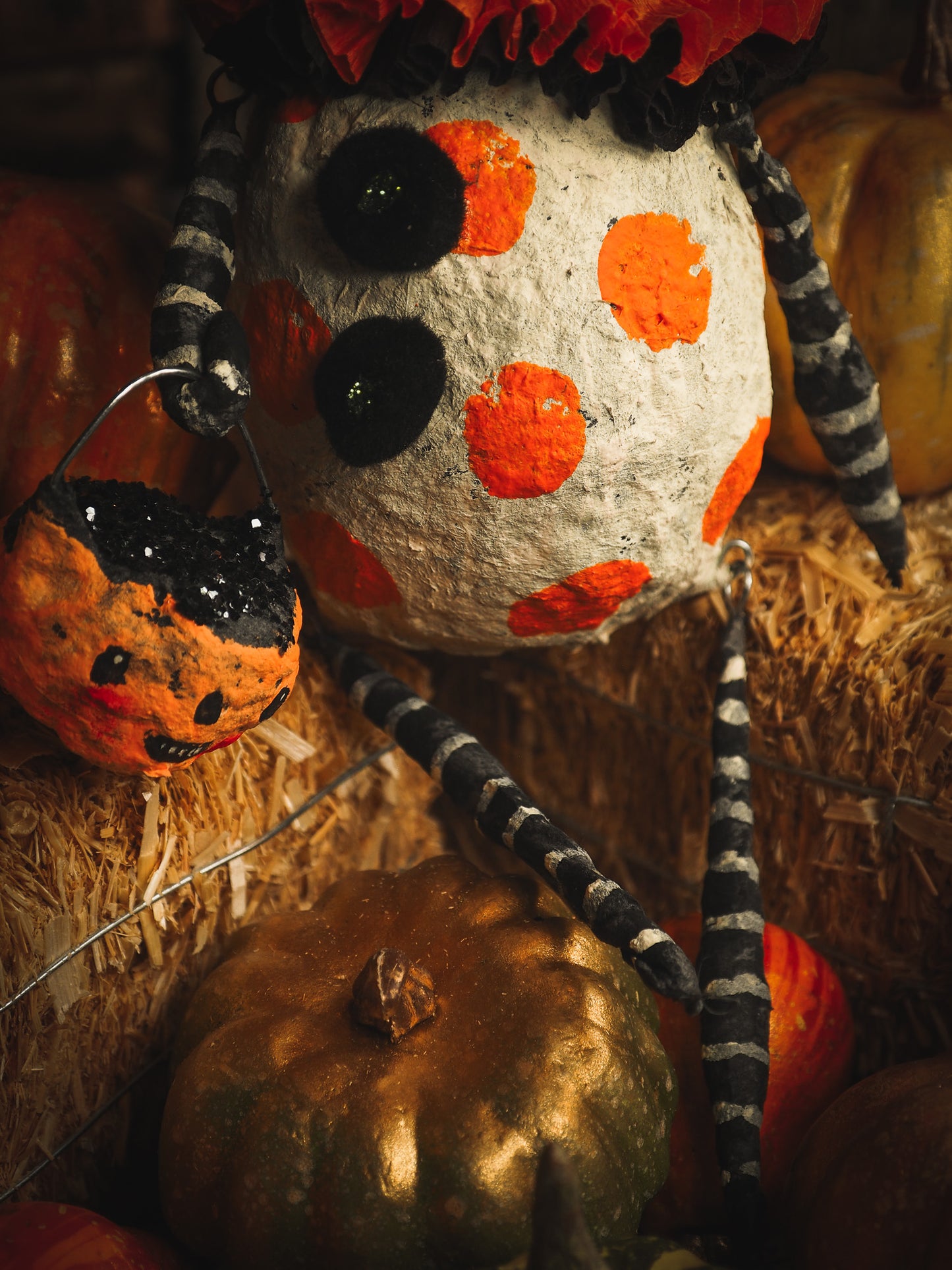 This adorable Halloween handmade ornament pumpkin jack-o-lantern doll monster by Idania Salcido, the artist behind Danita Art, is made with painted spun cotton and paper. It has hand painted face, teeth and eyes with a glittery paper had and matching paper costume. A Halloween home decoration on trick-or-treat night.