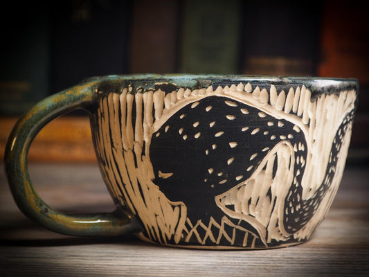 An original Halloween ceramic mug tumbler bowl handmade by Idania Salcido the artist behind Danita Art. Made with wheel thrown clay hand carved and glazed by the artist. Witches, ghosts, goblins, black cats, vampires give a folk art primitive feel to it. Perfect for Halloween Candy, ice cream and fruit, a pet cat bowl.