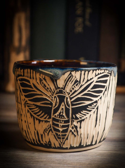 An original Halloween ceramic mug tumbler bowl handmade by Idania Salcido the artist behind Danita Art. Made with wheel thrown clay hand carved and glazed by the artist. Witches, ghosts, goblins, black cats, vampires give a folk art primitive feel to it. Perfect for Halloween Candy, ice cream and fruit, a pet cat bowl.