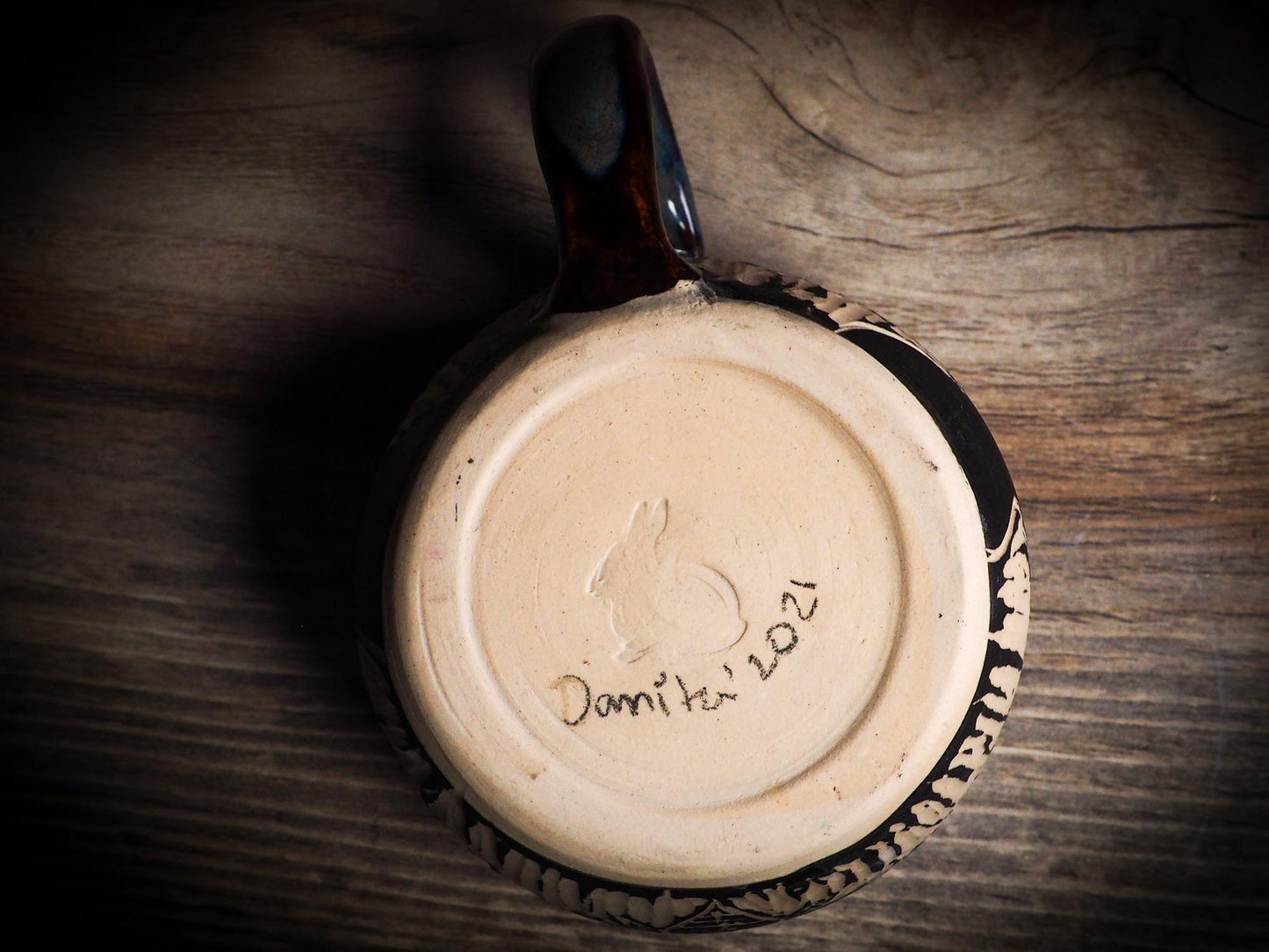 An original Halloween ceramic mug tumbler bowl handmade by Idania Salcido the artist behind Danita Art. Made with wheel thrown clay hand carved and glazed by the artist. Witches, ghosts, goblins, black cats, vampires give a folk art primitive feel to it. Perfect for Halloween Candy, ice cream and fruit, a pet cat bowl.