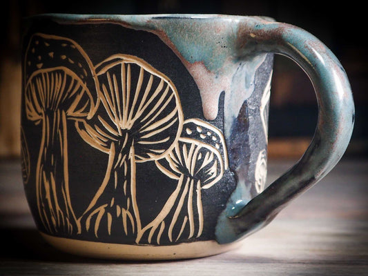 An original Halloween ceramic mug tumbler bowl handmade by Idania Salcido the artist behind Danita Art. Made with wheel thrown clay hand carved and glazed by the artist. Witches, ghosts, goblins, black cats, vampires give a folk art primitive feel to it. Perfect for Halloween Candy, ice cream and fruit, a pet cat bowl.