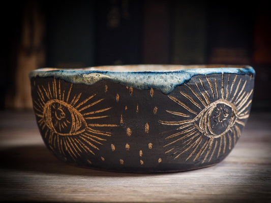 An original Halloween ceramic mug tumbler bowl handmade by Idania Salcido the artist behind Danita Art. Made with wheel thrown clay hand carved and glazed by the artist. Witches, ghosts, goblins, black cats, vampires give a folk art primitive feel to it. Perfect for Halloween Candy, ice cream and fruit, a pet cat bowl.