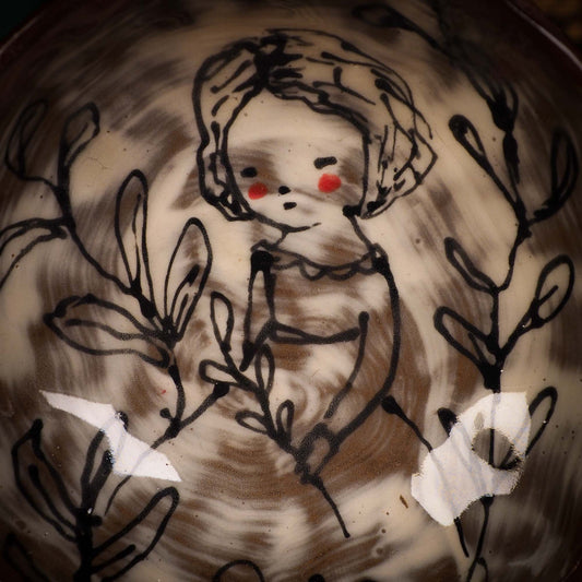 An original glazed ceramic food bowl by Idania Salcido, the artist behind Danita Art. Totally handmade in my studio, this is a unique piece that cannot be repeated. Food and drink safe, hand wash only. Brown earth tones and an ink drawing of a girl collecting plants on the inside.