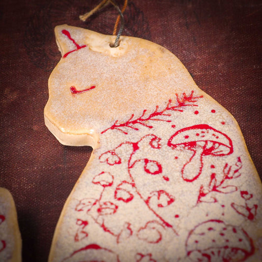 An original Christmas Holiday tree ornament ceramic cat, handmade by Idania Salcido the artist behind Danita Art. Glazed carved sgraffito stoneware, hand painted and decorated, it has a beautiful vintage glass tree ornament to adorn a unique holiday gift for family and friends. Christmas gift for animal and pet lovers.