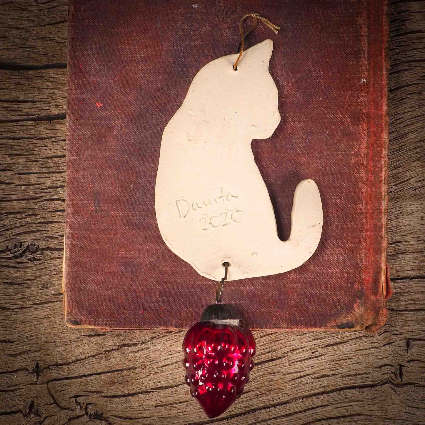 An original Christmas Holiday tree ornament ceramic cat, handmade by Idania Salcido the artist behind Danita Art. Glazed carved sgraffito stoneware, hand painted and decorated, it has a beautiful vintage glass tree ornament to adorn a unique holiday gift for family and friends. Christmas gift for animal and pet lovers.